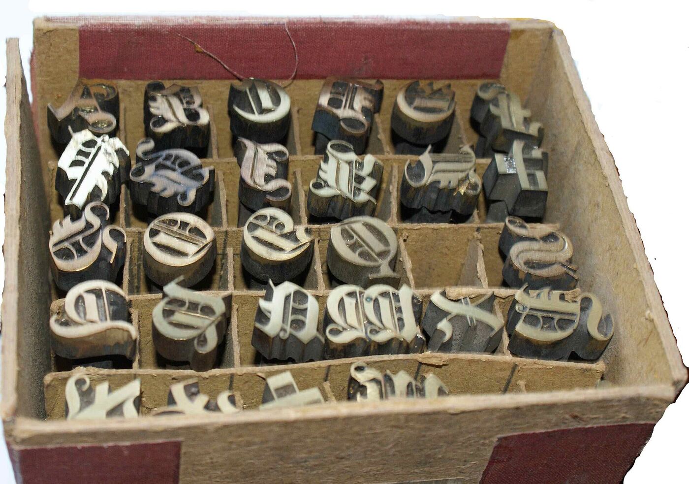 A box of brass letter stamps used for printing book covers
